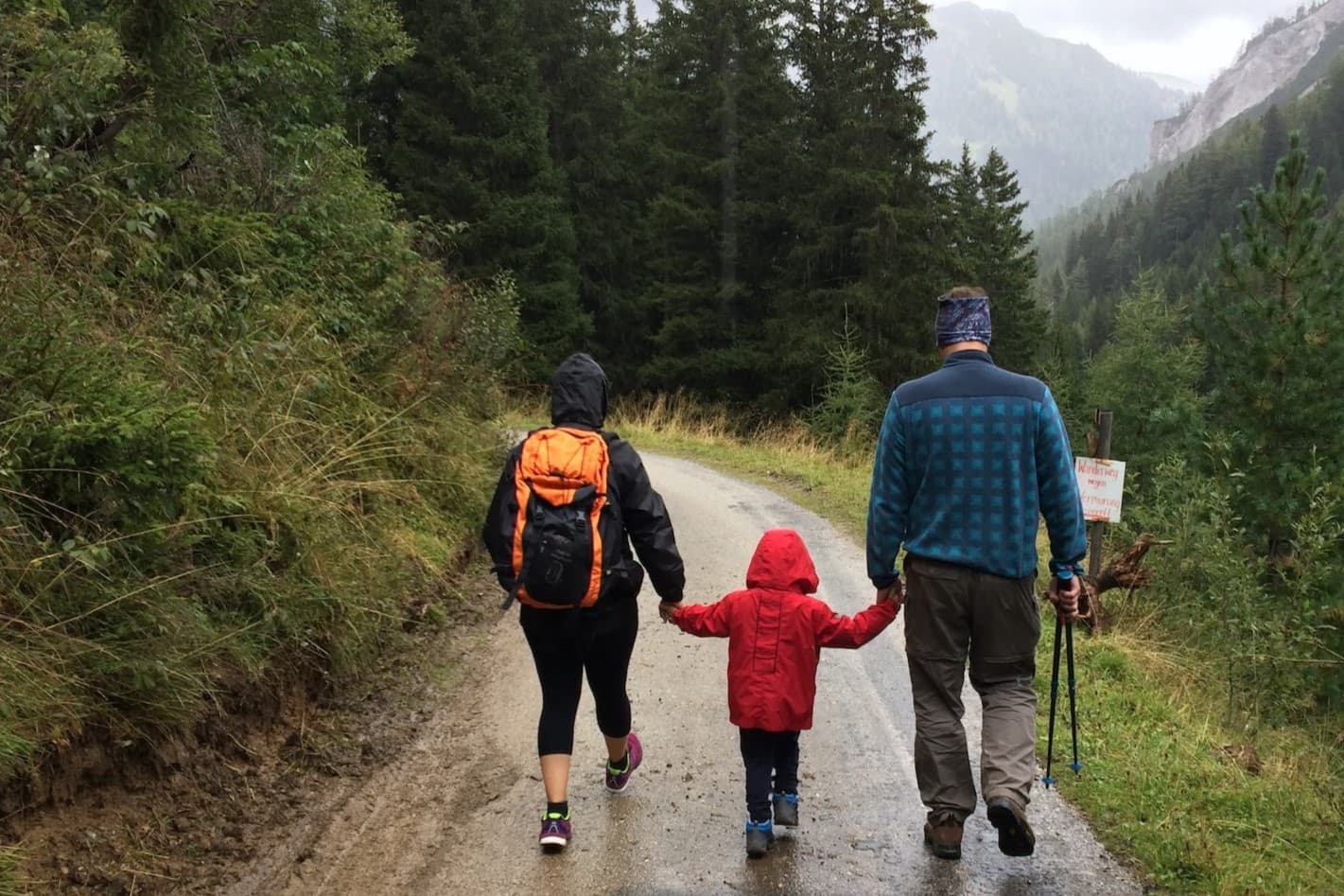 Mother, father and child holding hands hiking together Mother, father and child holding hands hiking together