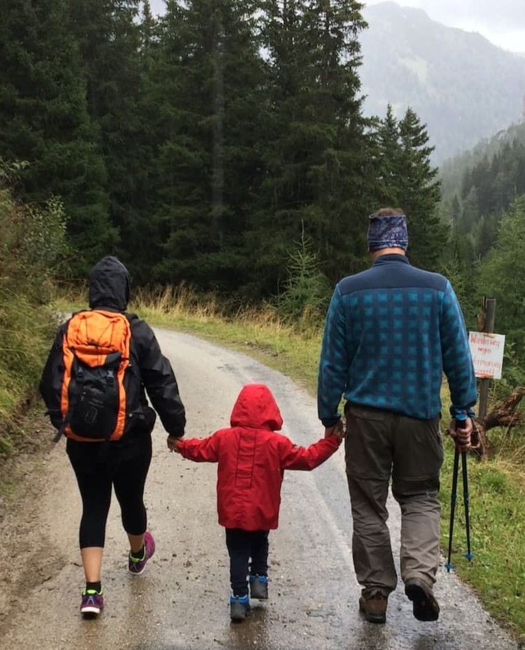 Mother, father and child holding hands hiking together