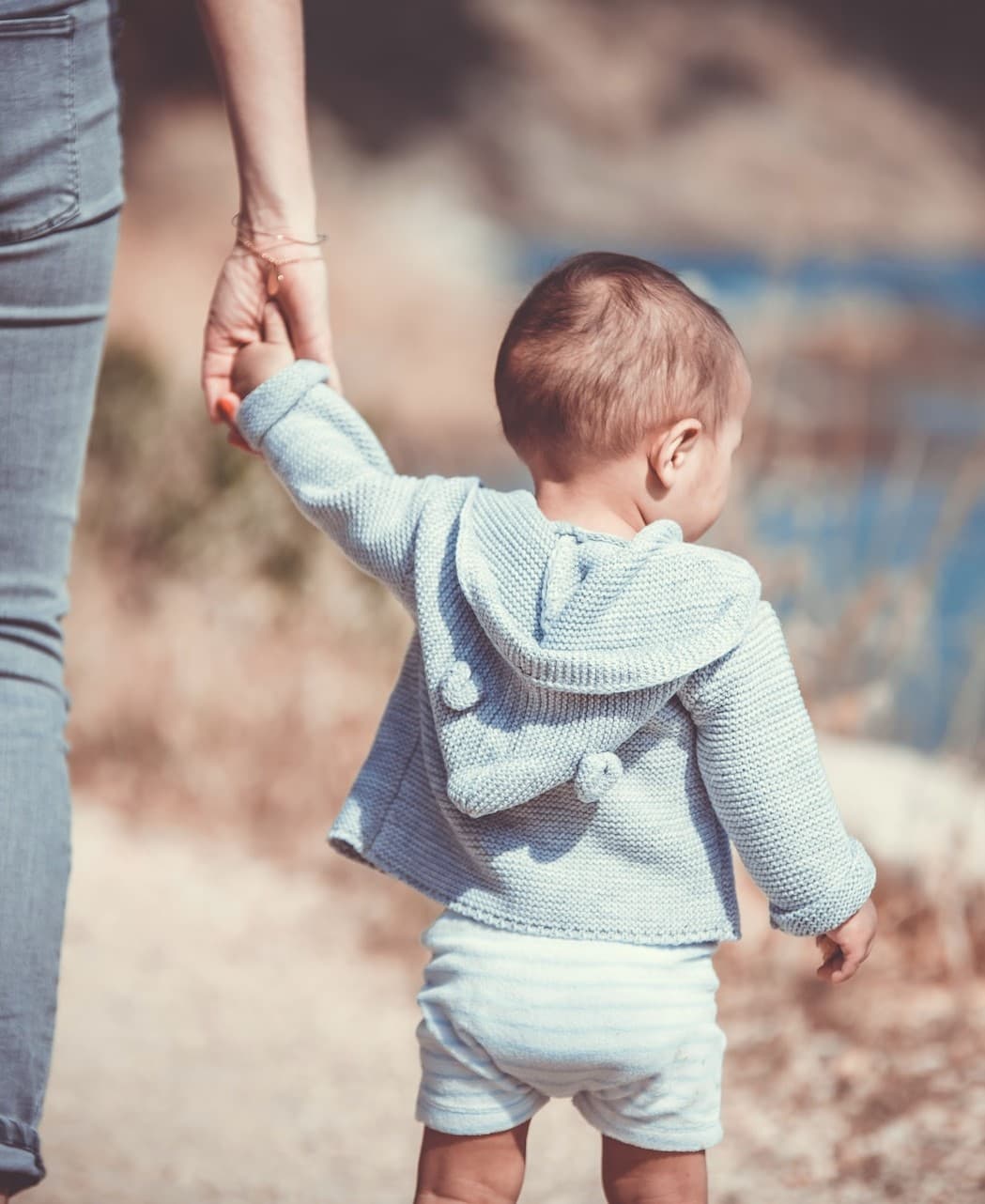 Mother and daughter holding hands walking together Mother and daughter holding hands walking together