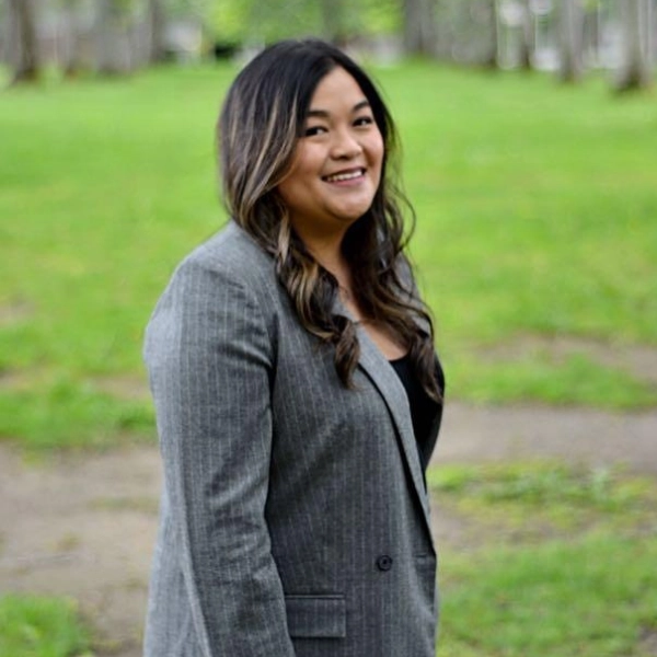 Pam Penaranda, Legal Assistant at Pathway Legal, dressed in a pinstripe blazer. She supports clients and lawyers with case preparation, document management, and compassionate communication.