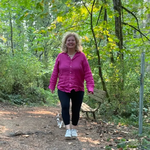 Val Hemminger walking in a bush setting