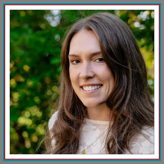 Professional outdoor headshot of Diana Illy, Paralegal at Pathway Legal, smiling warmly with long brunette hair, wearing a cream lace top and gold necklace against a soft green background.